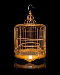A Chinese Bamboo Bird Cage with A Pair of Wucai Porcelain Bird Feeders