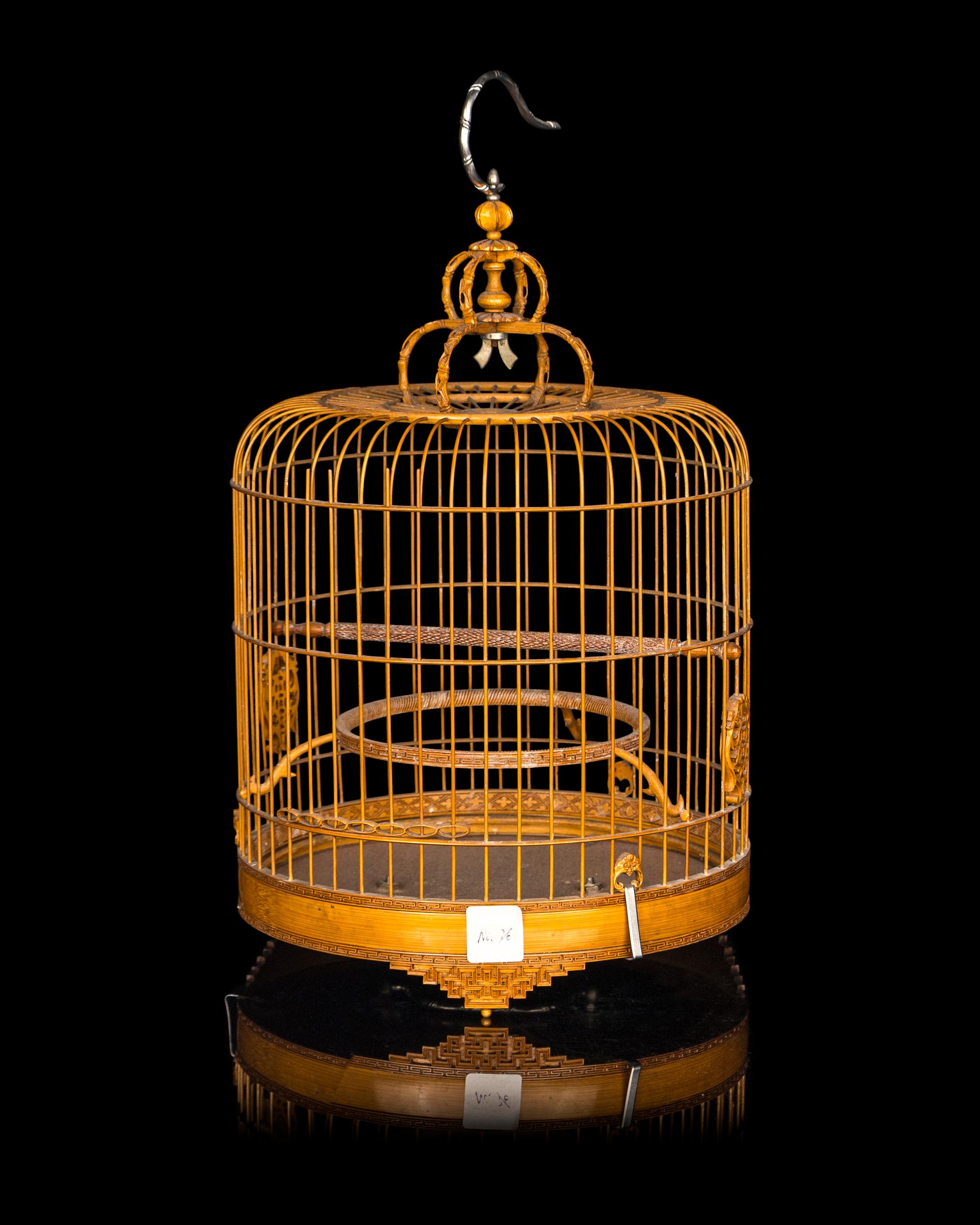 A Chinese Bamboo Bird Cage with A Pair of Wucai Porcelain Bird Feeders
