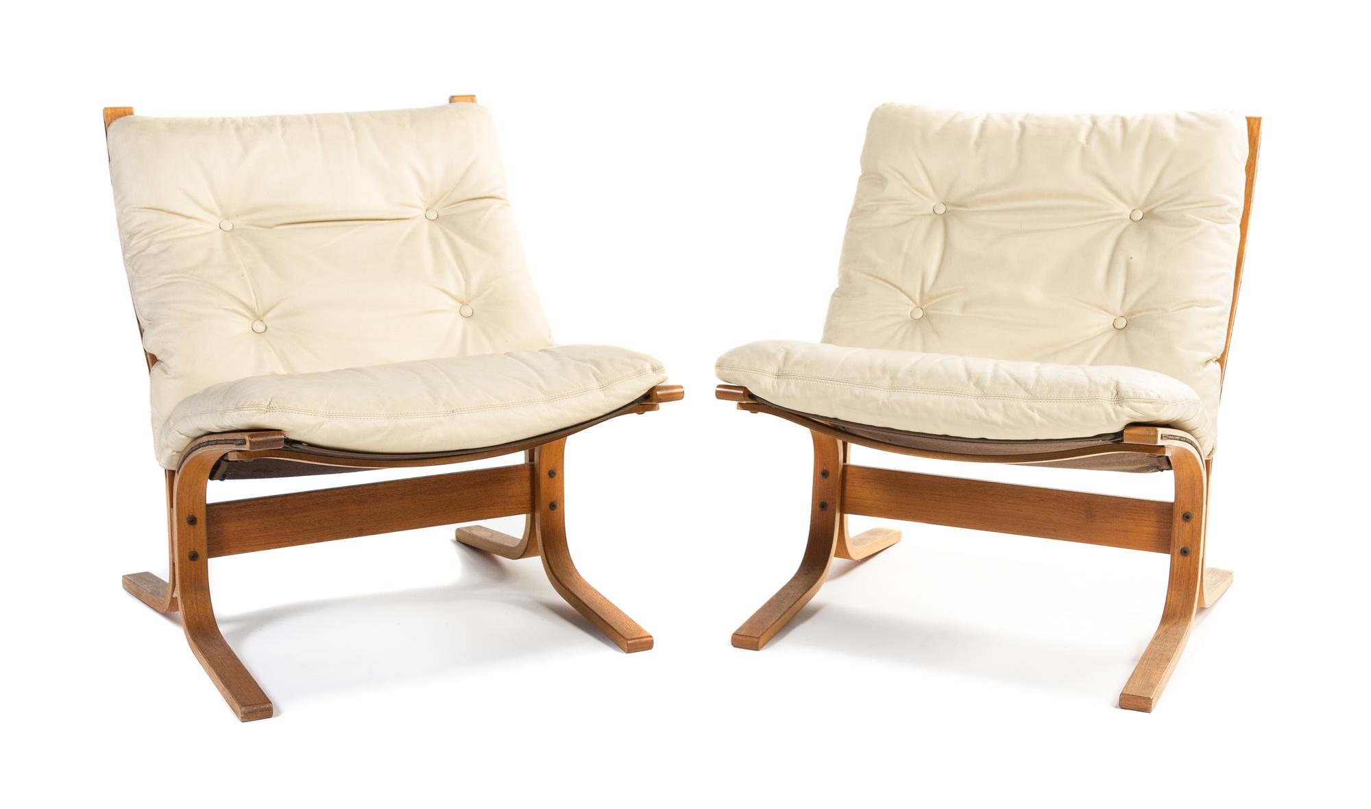 A Pair of Danish Westnofa Teak Lounge Chairs Height 30 3/4 inches.