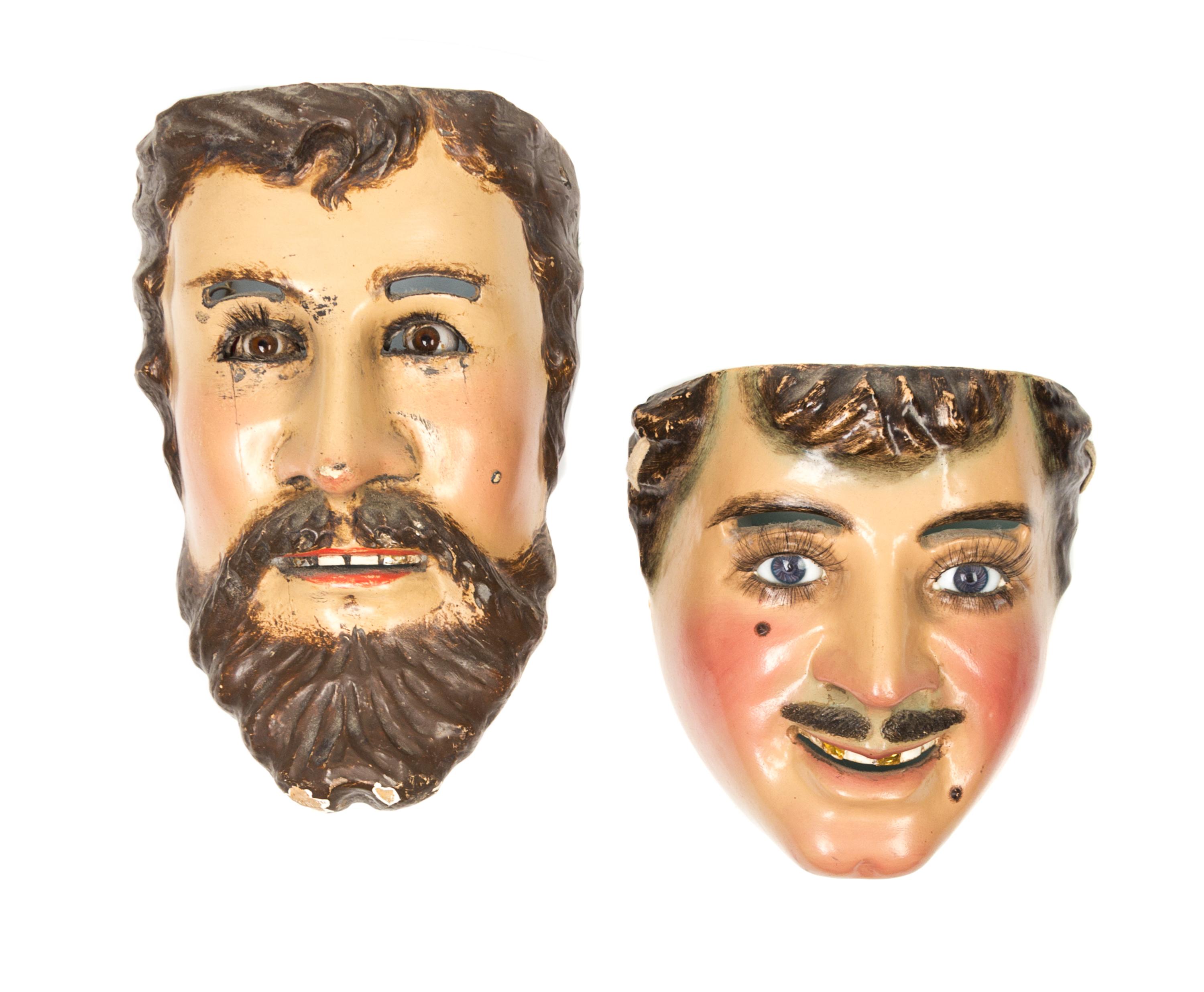 Two Mexican Polychromed Wood and Glass Masks Height 10 inches.
