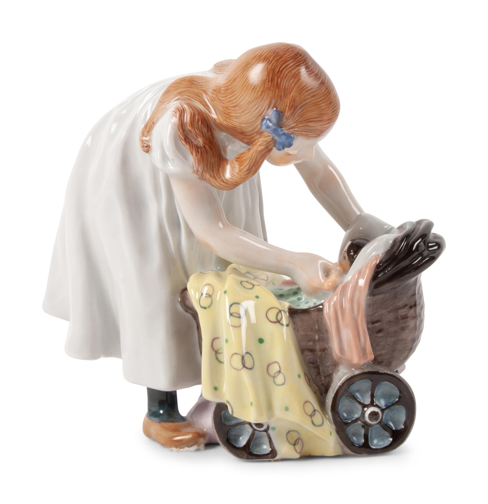 A Meissen Porcelain Figure of a Girl with a Doll Stroller, by Konrad Hentschel