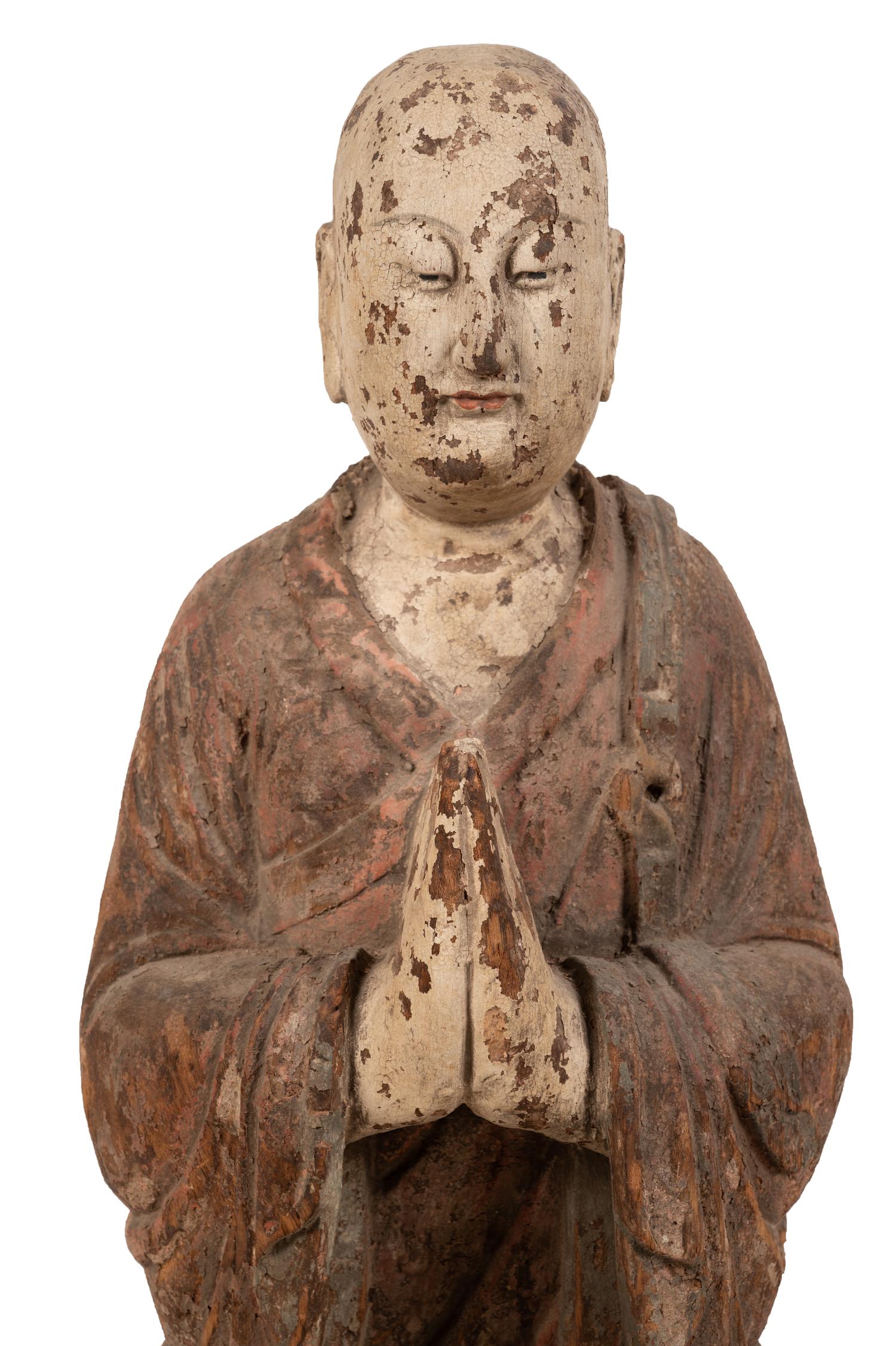 A Chinese Carved and Polychrome Decorated Wood Figure in Prayer
