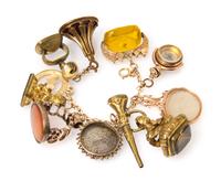 A Yellow Gold Charm Bracelet with 12 Attached Fobs and Charms, 74.90 dwts.