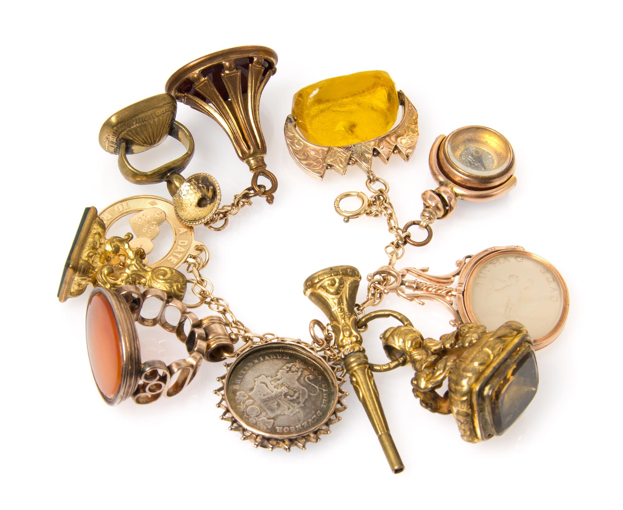 A Yellow Gold Charm Bracelet with 12 Attached Fobs and Charms, 74.90 dwts.
