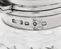 Three Victorian Silver Mounted Cut Glass Bottles