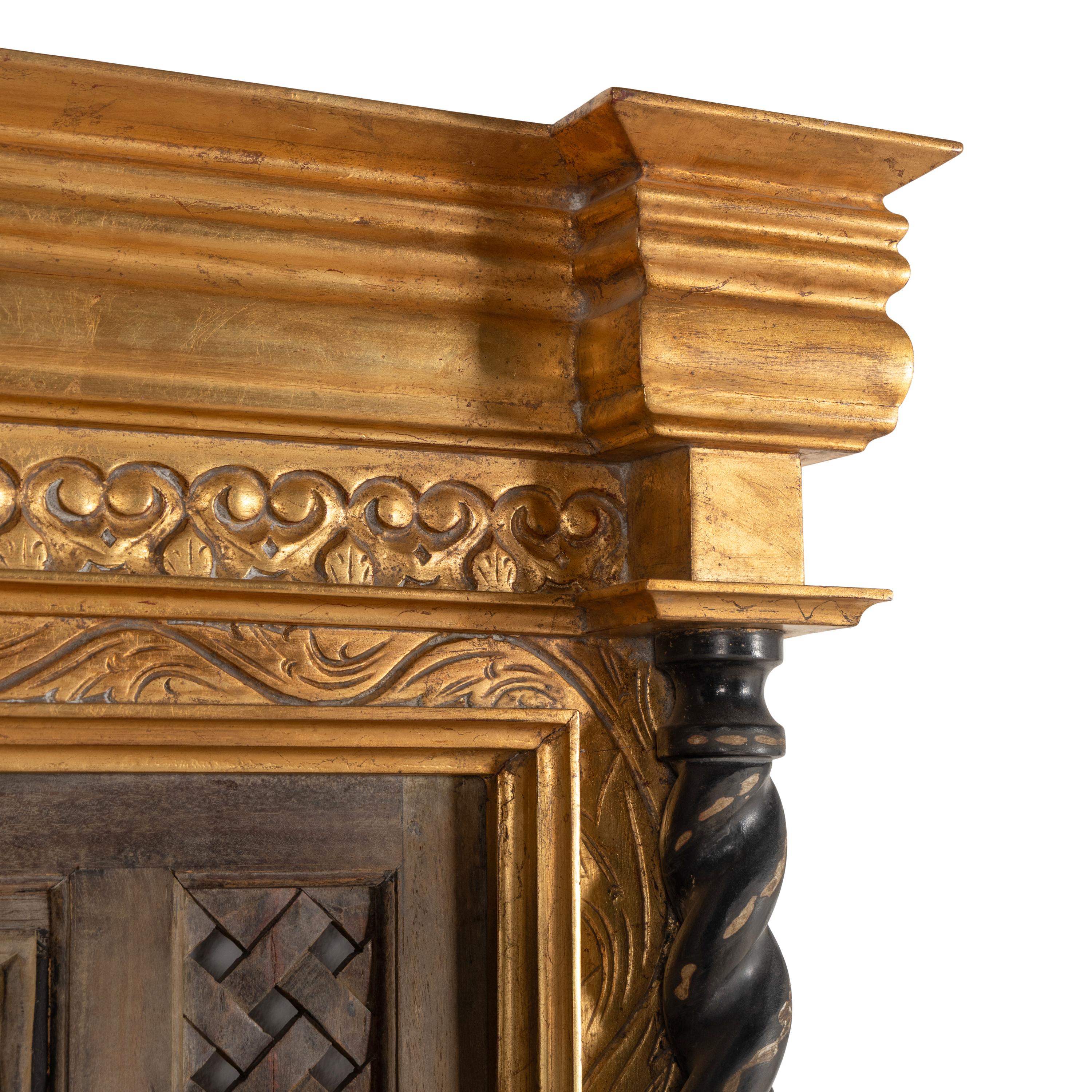 A Southeast Asian Giltwood and Carved Teak Mirror