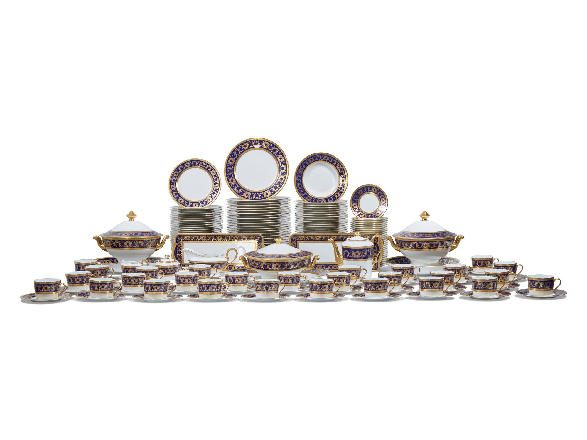 A Tharaud- Limoges Parcel Gilt and Cobalt Decorated Porcelain Dinner Service