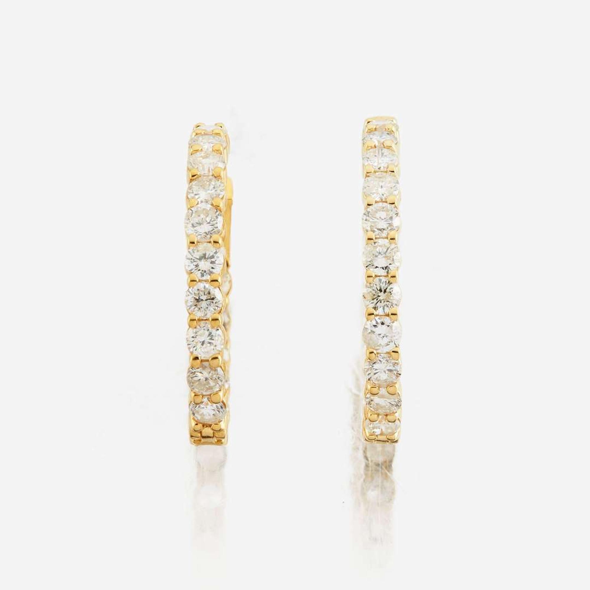 A pair of diamond and gold earrings