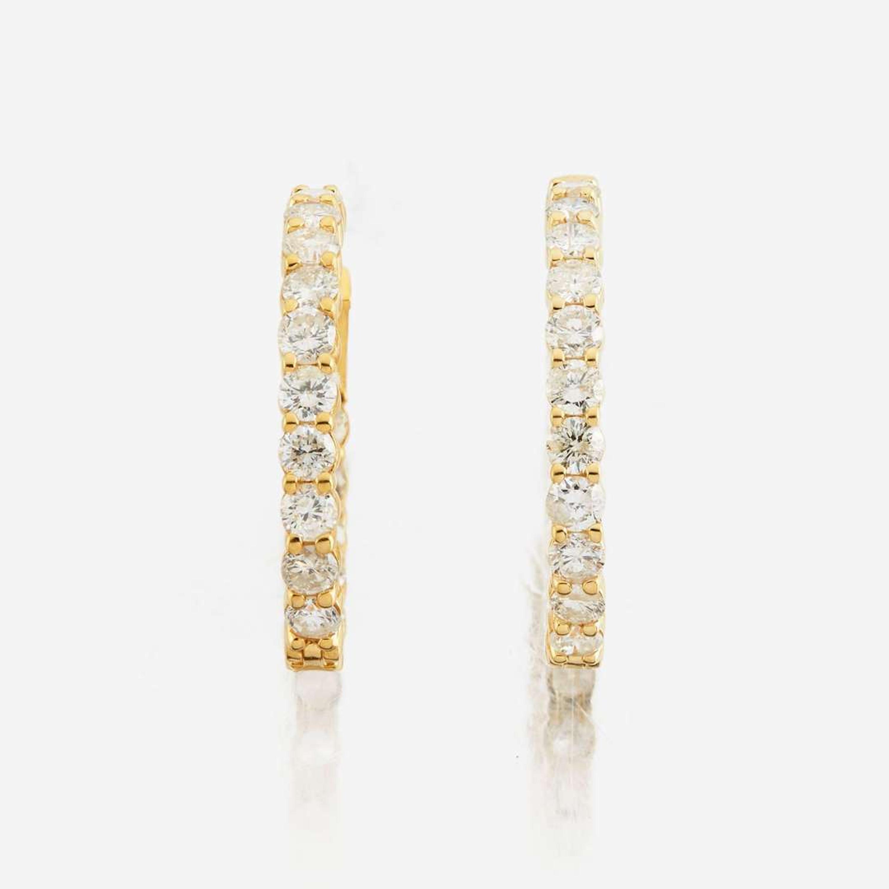A pair of diamond and gold earrings