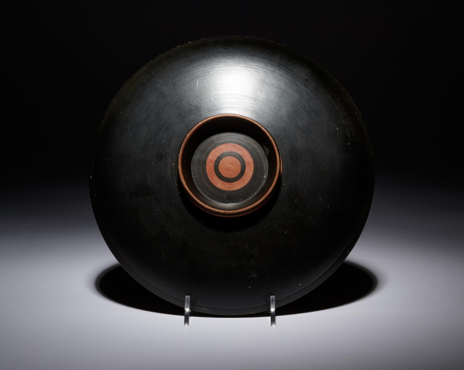 An Apulian Red-Figured Plate with Striding Eros