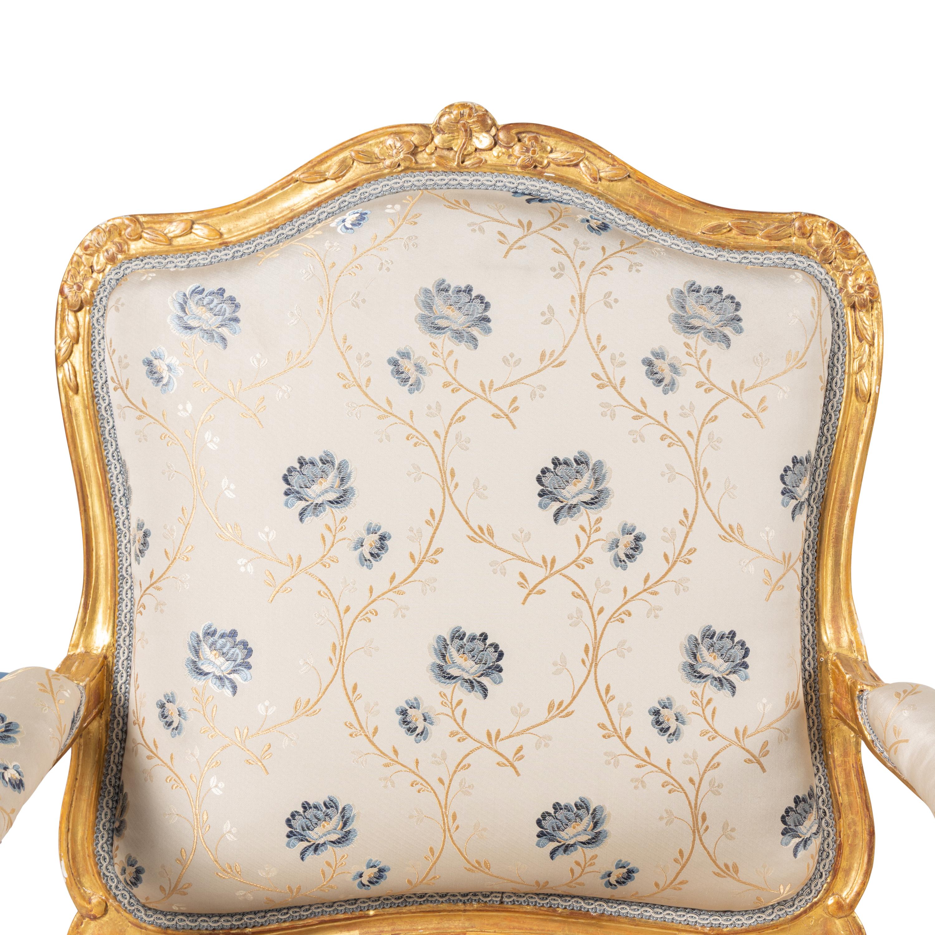A Pair of Louis XV Carved and Giltwood Fauteuils à la Reine