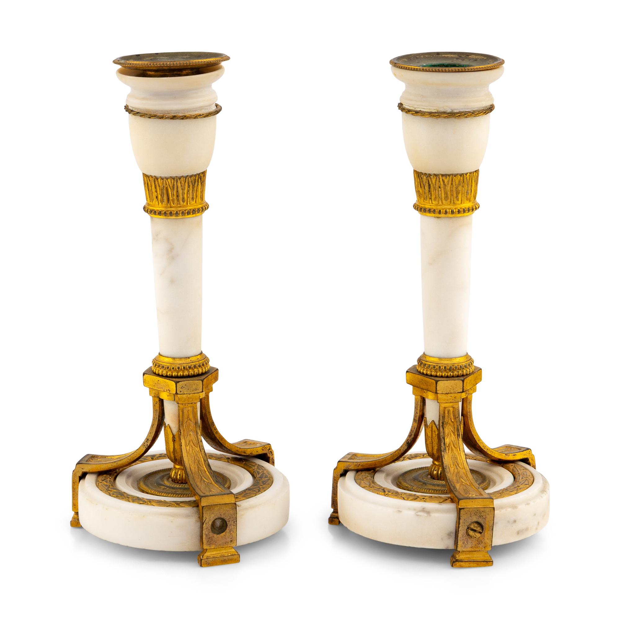 A Pair of Directoire Gilt Bronze and White Marble Candlesticks