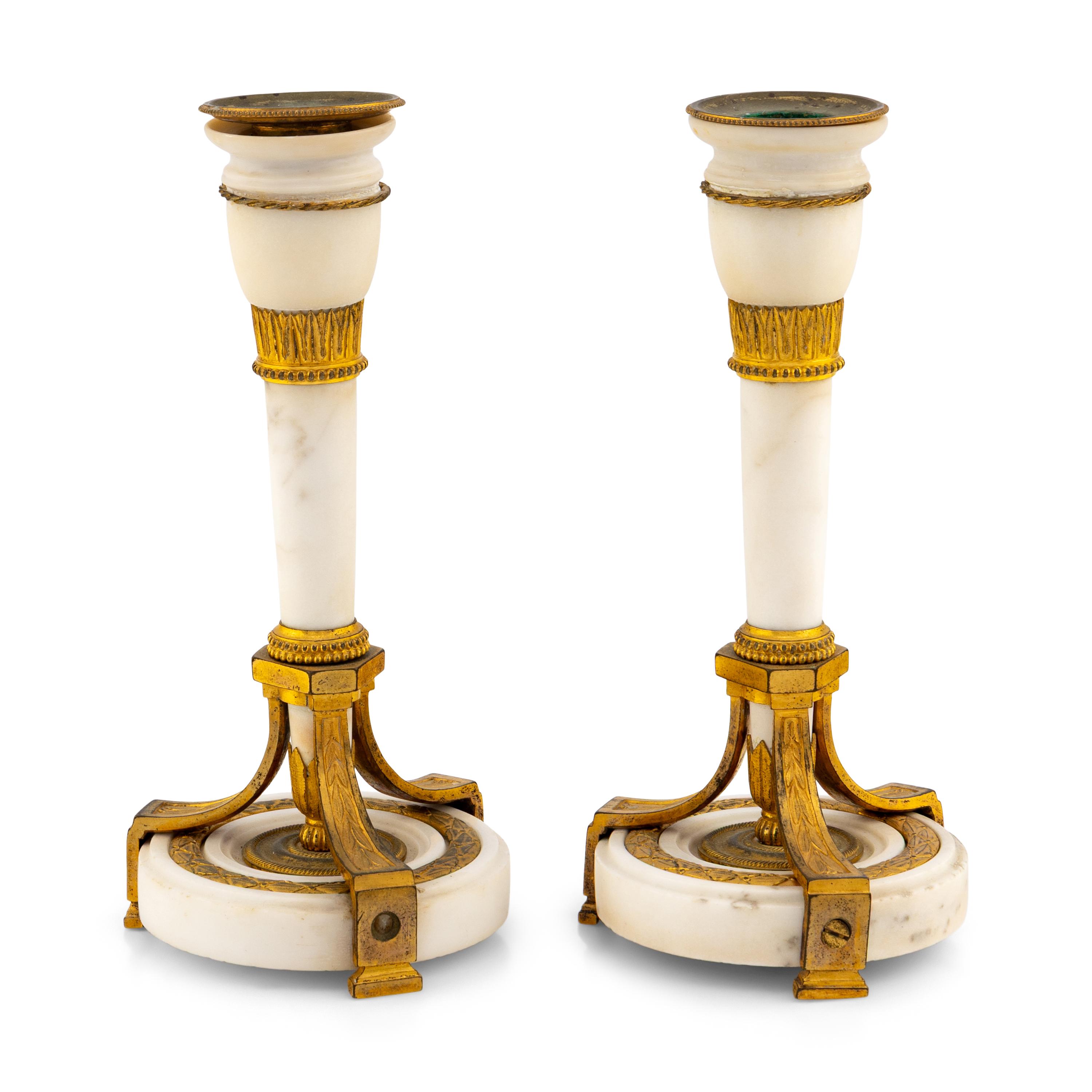 A Pair of Directoire Gilt Bronze and White Marble Candlesticks