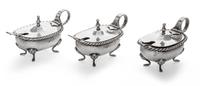 A Set of Three Italian Silver Salts, 19th/20th Century, oval with twisted rims and raised on four paw supports, scroll handles, with th