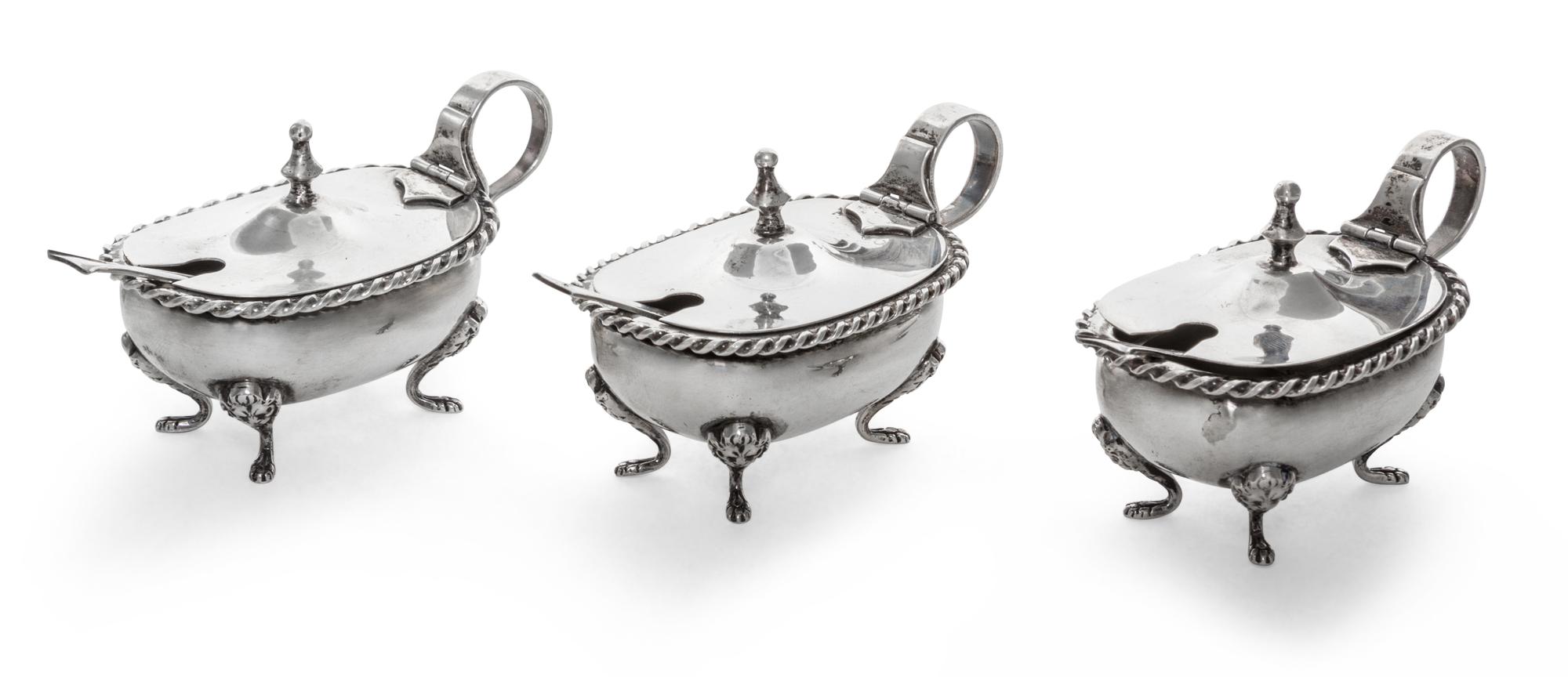 A Set of Three Italian Silver Salts, 19th/20th Century, oval with twisted rims and raised on four paw supports, scroll handles, with th