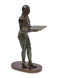 A Patinated Bronze Figure of an Egyptian as an Offering-Bearer
