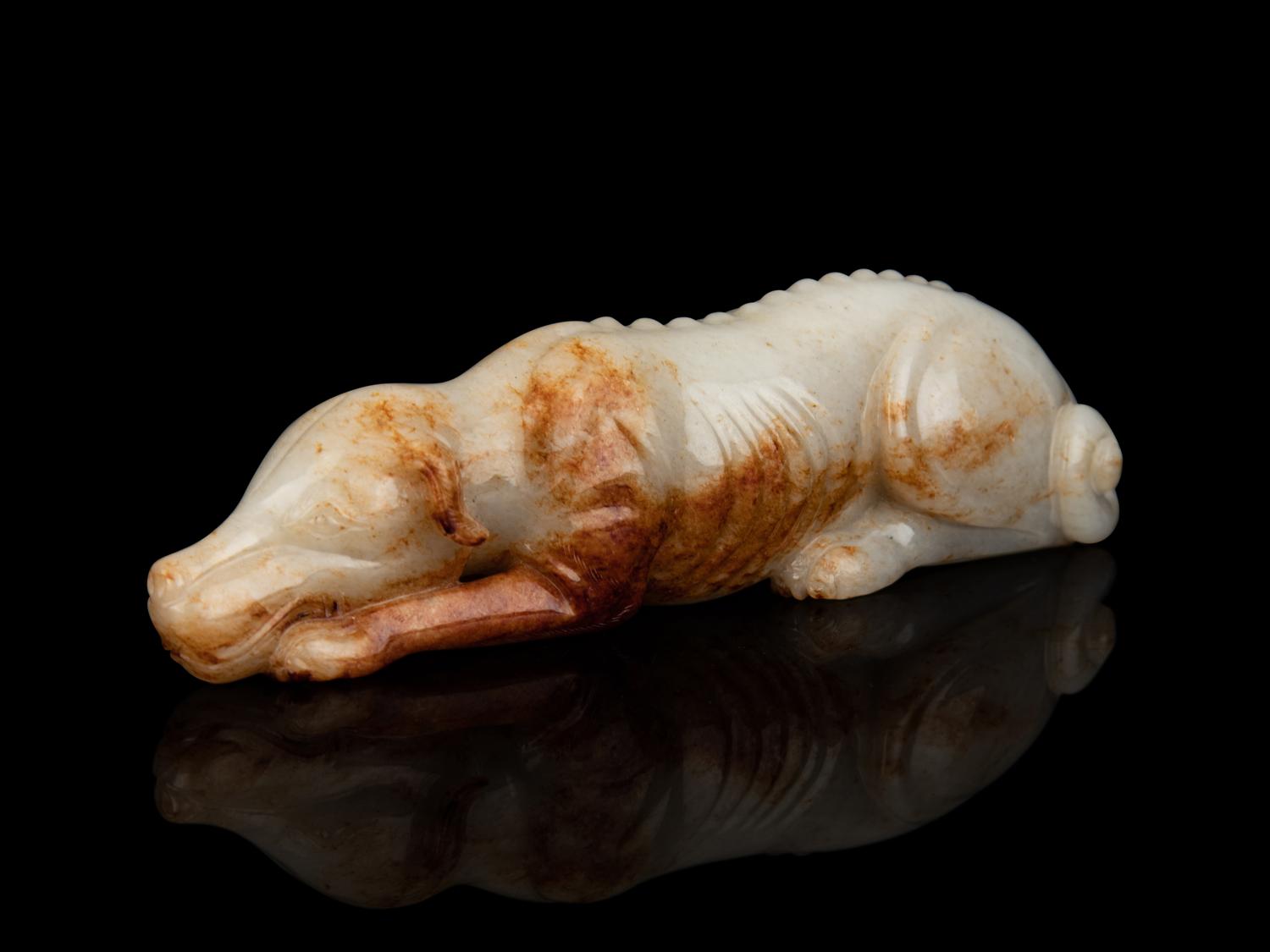 A White and Russet Jade Figure of a Recumbent Dog