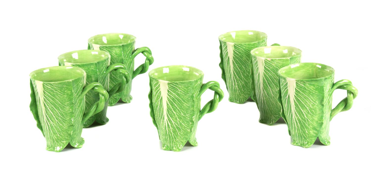 A Set of Seven Dodie Thayer Lettuce Ware Mugs Height 5 1/4 inches.