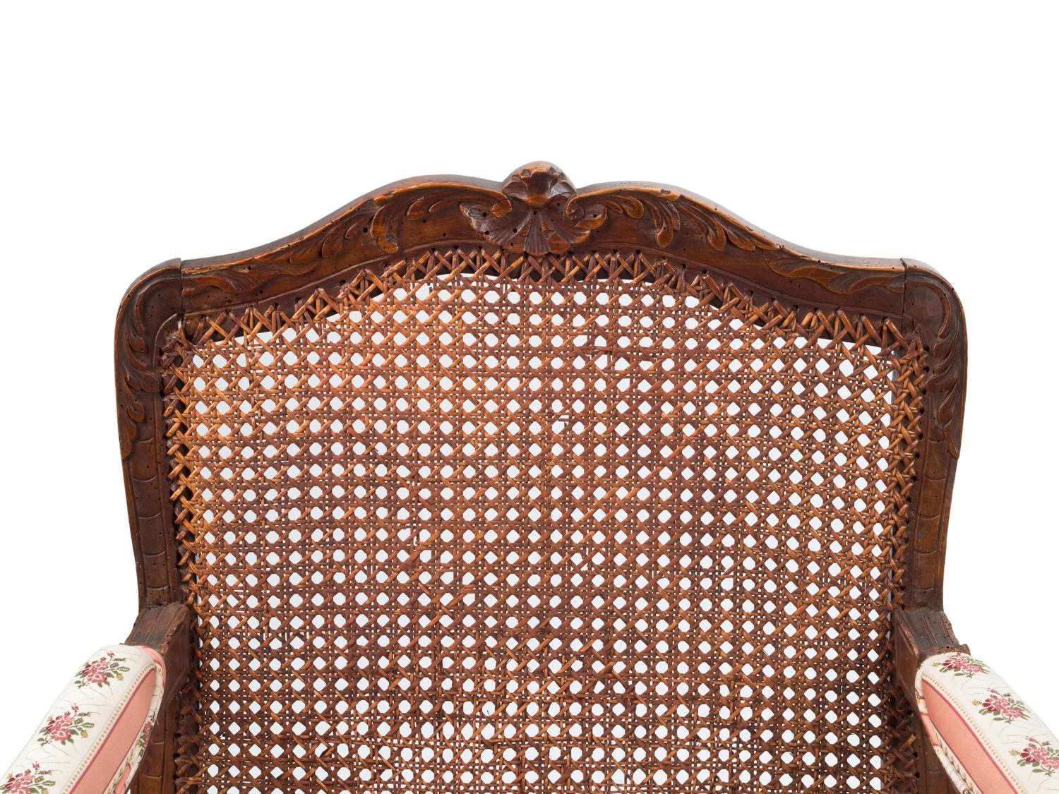 A Pair of Louis XV Provincial Walnut Caned Fauteuils