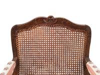 A Pair of Louis XV Provincial Walnut Caned Fauteuils