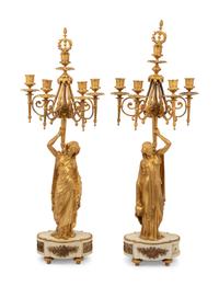 A Louis XVI Style Gilt Bronze and Marble Figural Clock Garniture