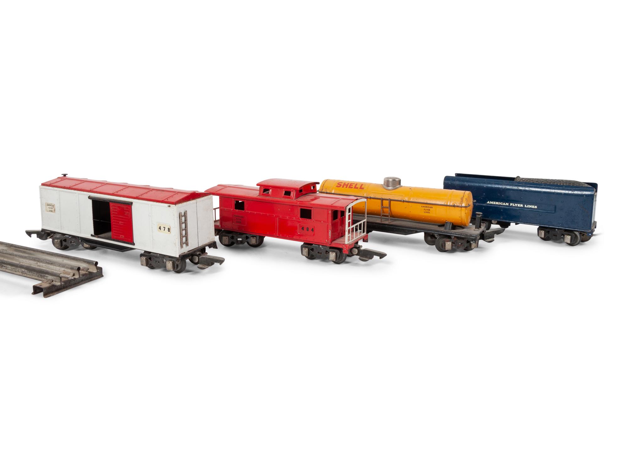 A Lionel 385E Loco Engine and Tender, Three Lionel Train Cars, Four American Flyer Line Cars and Other Accessories
