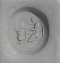 A Roman Carnelian Ring Stone with a Satyr Mixing Wine — Set in a gold ring