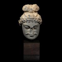 A Gandharan Grey Schist Head of a Bodhisattva, 2nd/3rd Century