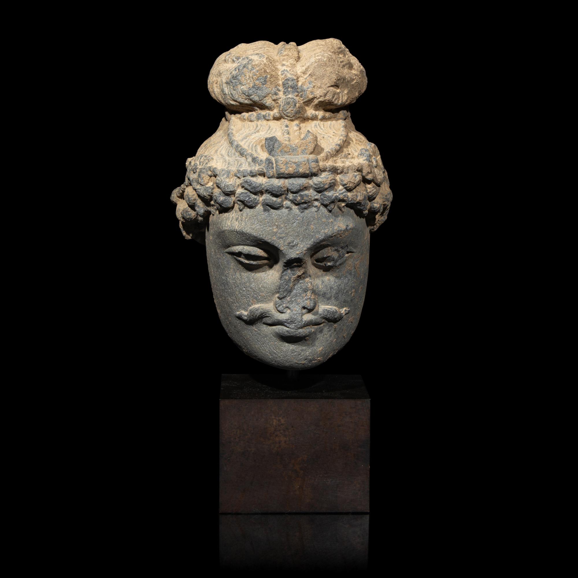 A Gandharan Grey Schist Head of a Bodhisattva, 2nd/3rd Century