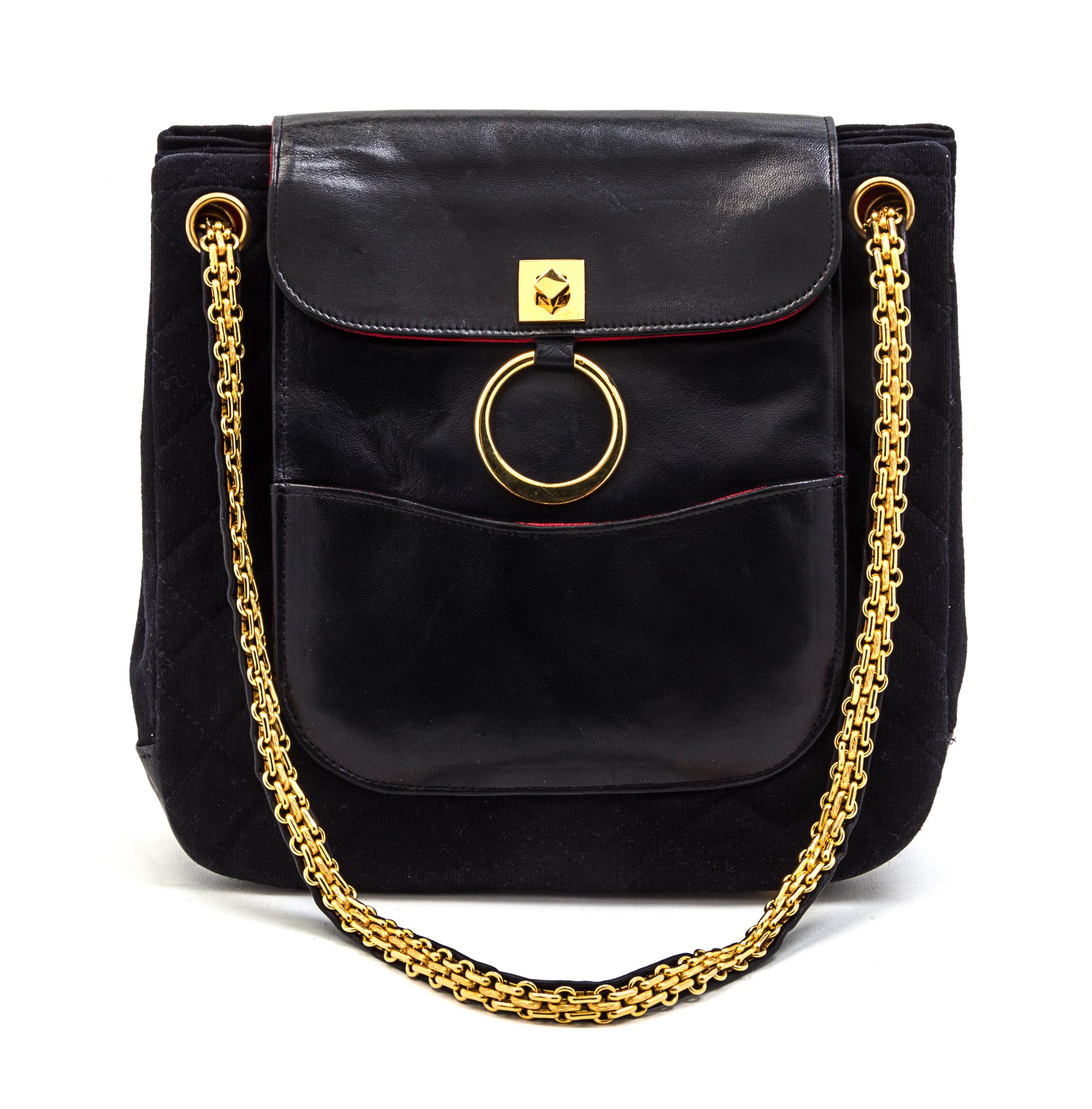 A Chanel Navy Quilted Jersey and Leather Bag, 9 x 8 1/2 x 3 inches.