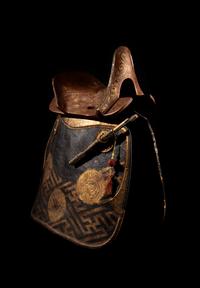 A Gilt and Polychrome Painted Red Lacquer Saddle and Two Pads