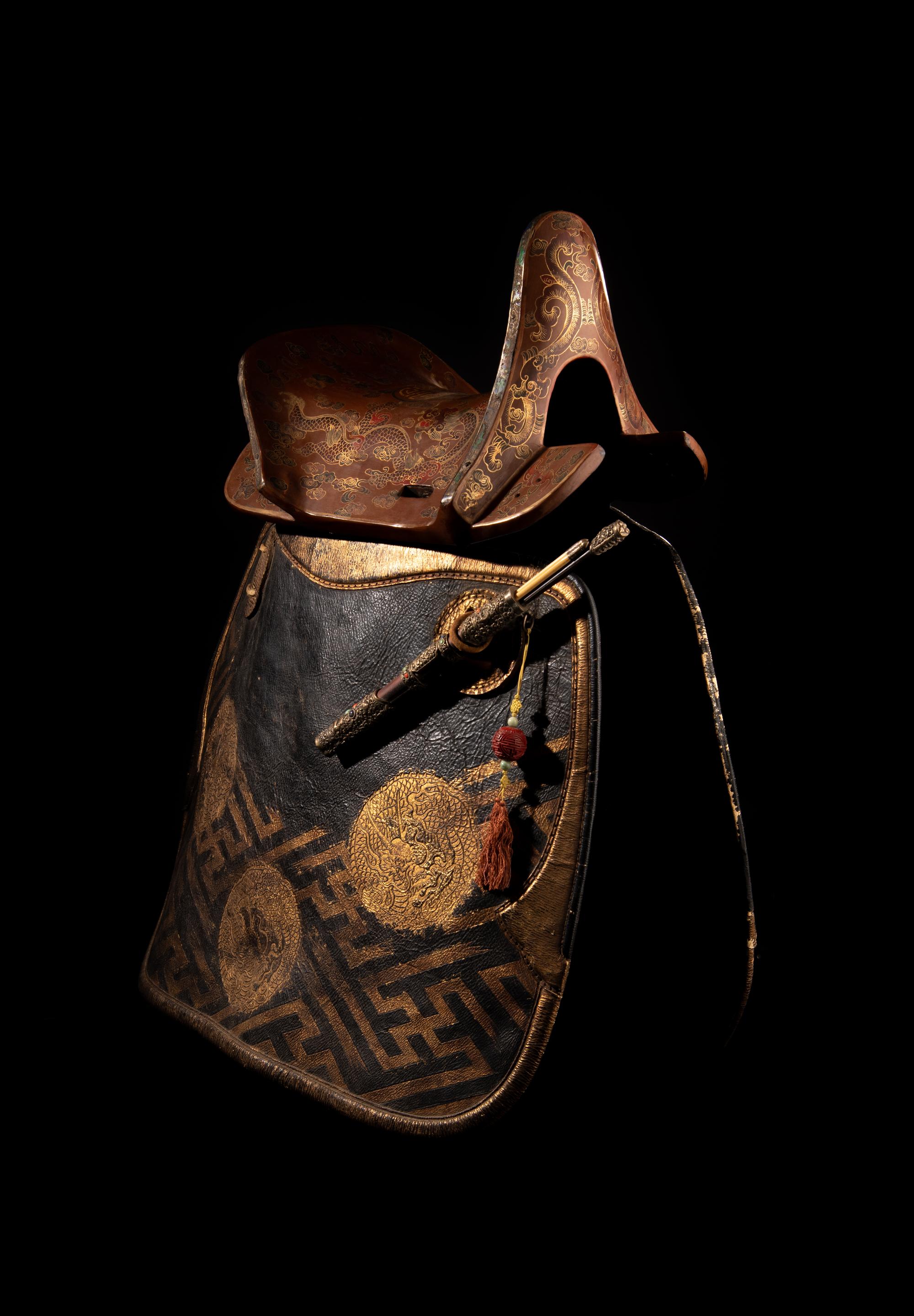 A Gilt and Polychrome Painted Red Lacquer Saddle and Two Pads