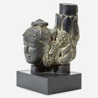 An Indian carved black stone head of a female Gahadavala Dynasty, 12th Century