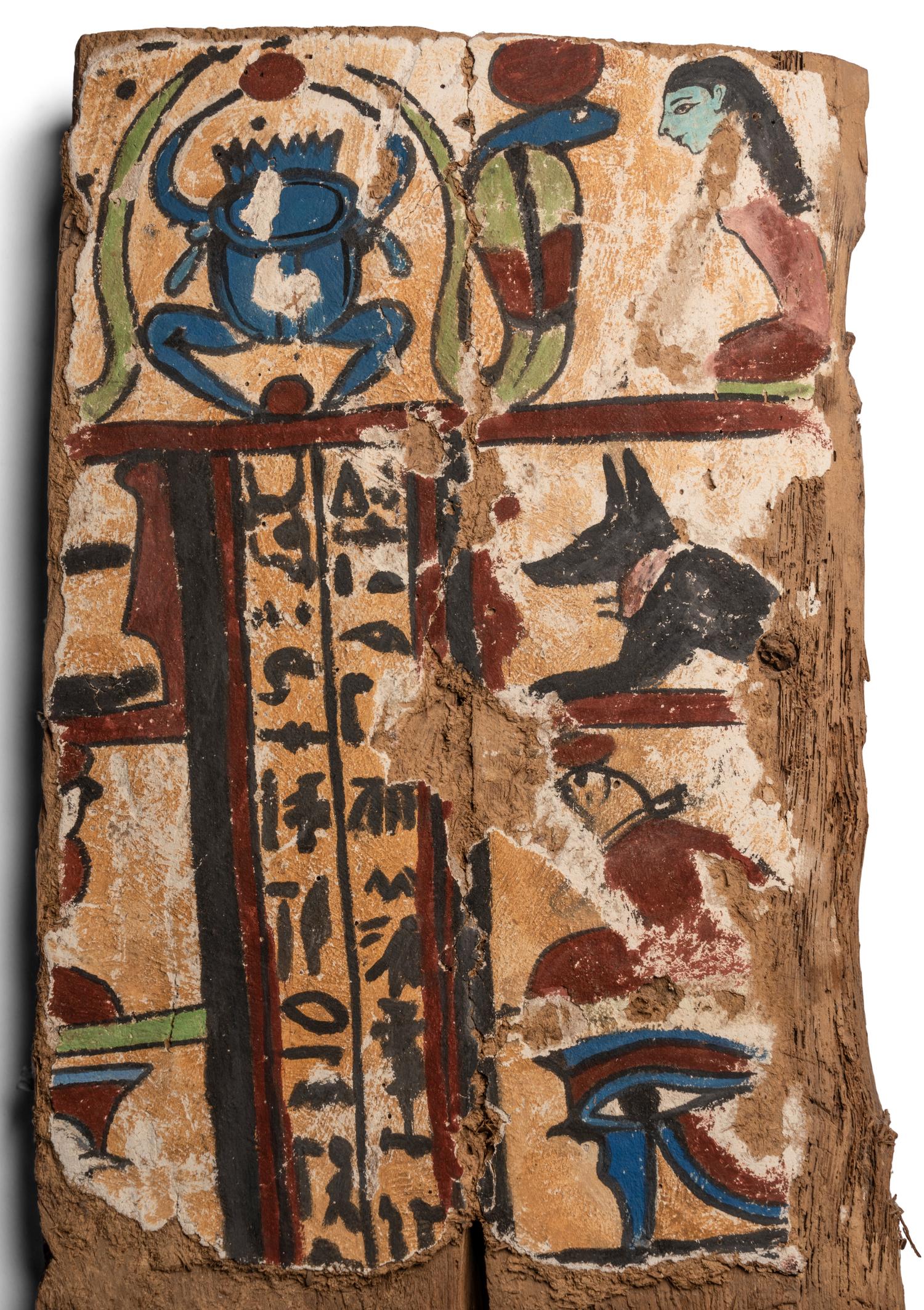 An Egyptian Painted Wood Sarcophagus Fragment with a Scarab