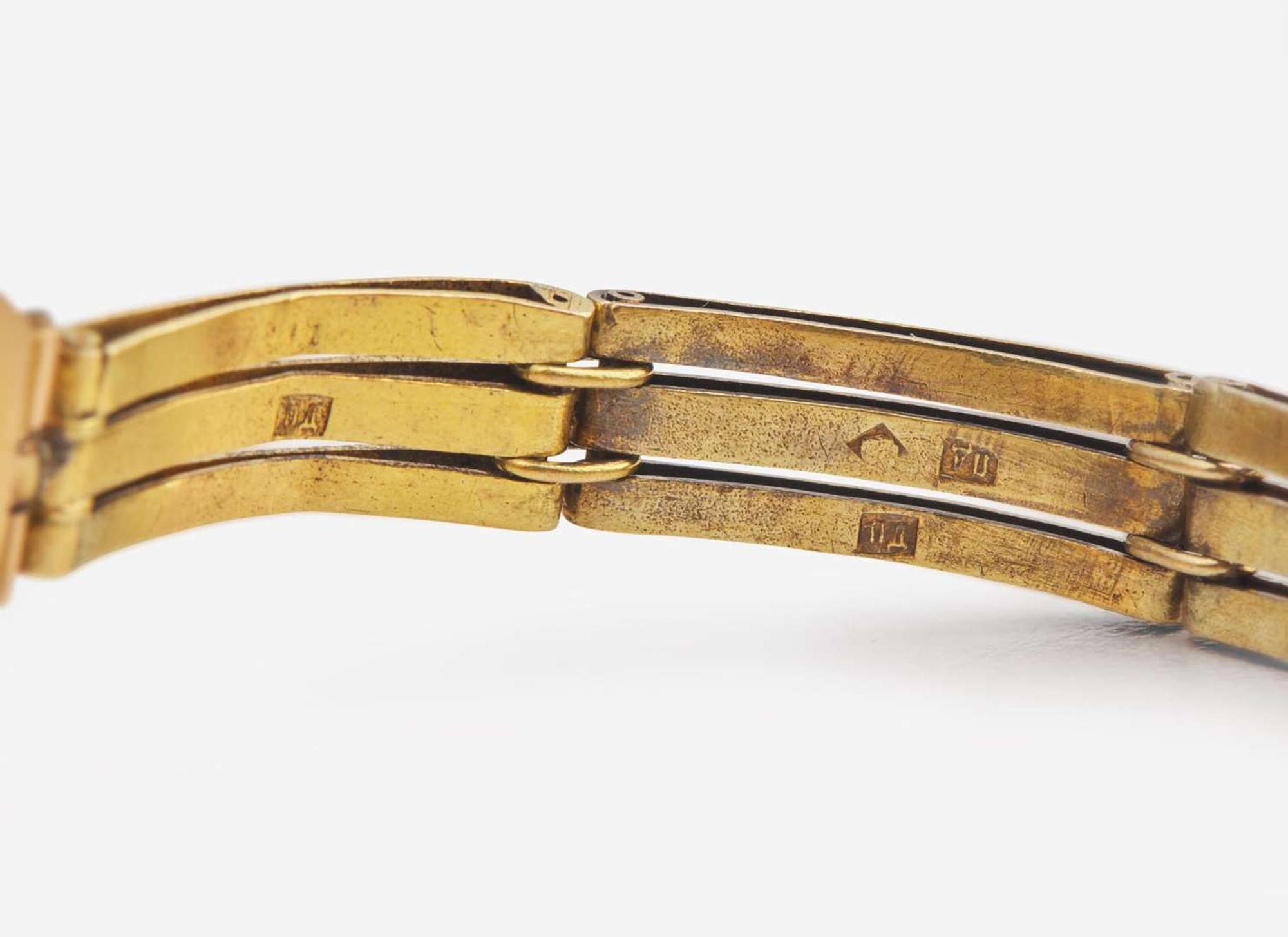 A Ladies 14K Yellow Gold Russian Invicta Watch with Diamonds