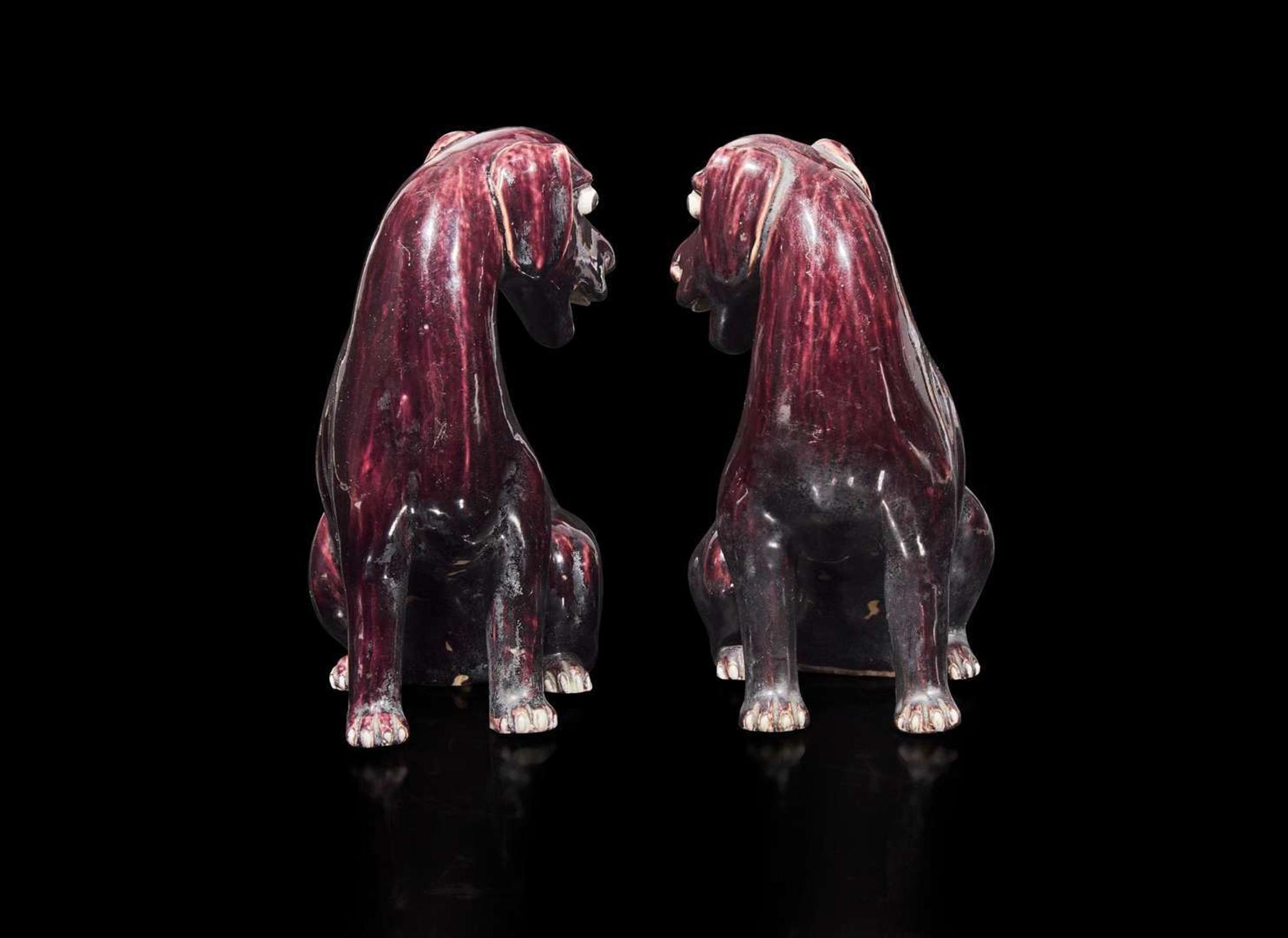 A pair of Chinese export aubergine-glazed porcelain seated dogs, 茄紫釉小狗一對