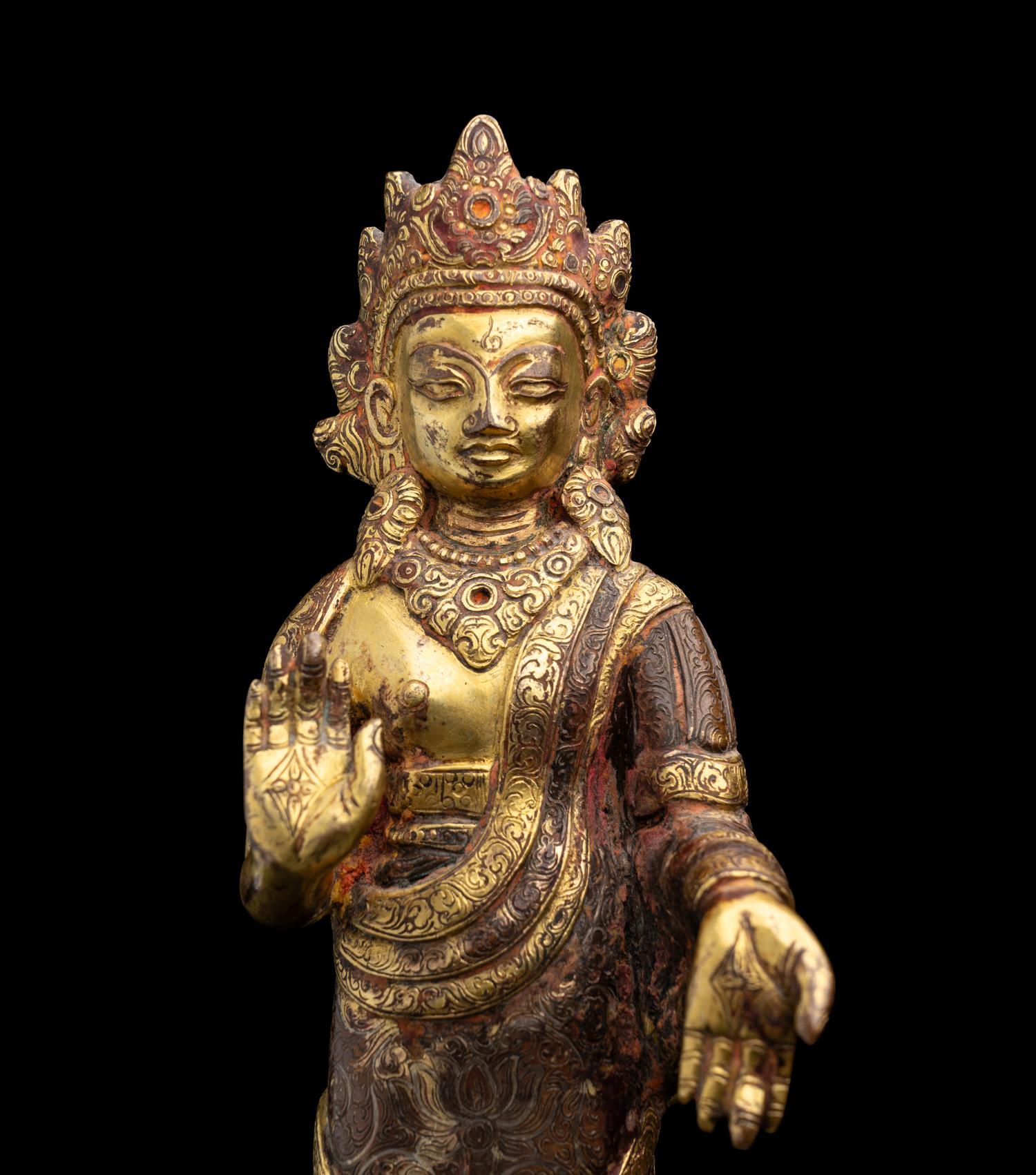 A Nepalese Gilt Bronze Standing Figure of Dipankara