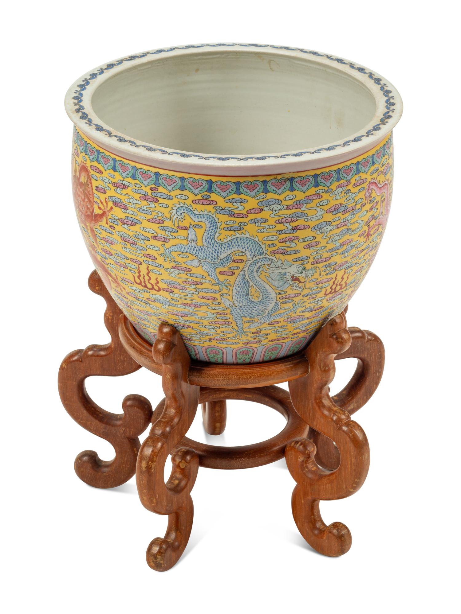 A Chinese Porcelain Jardinière on a Wood Stand