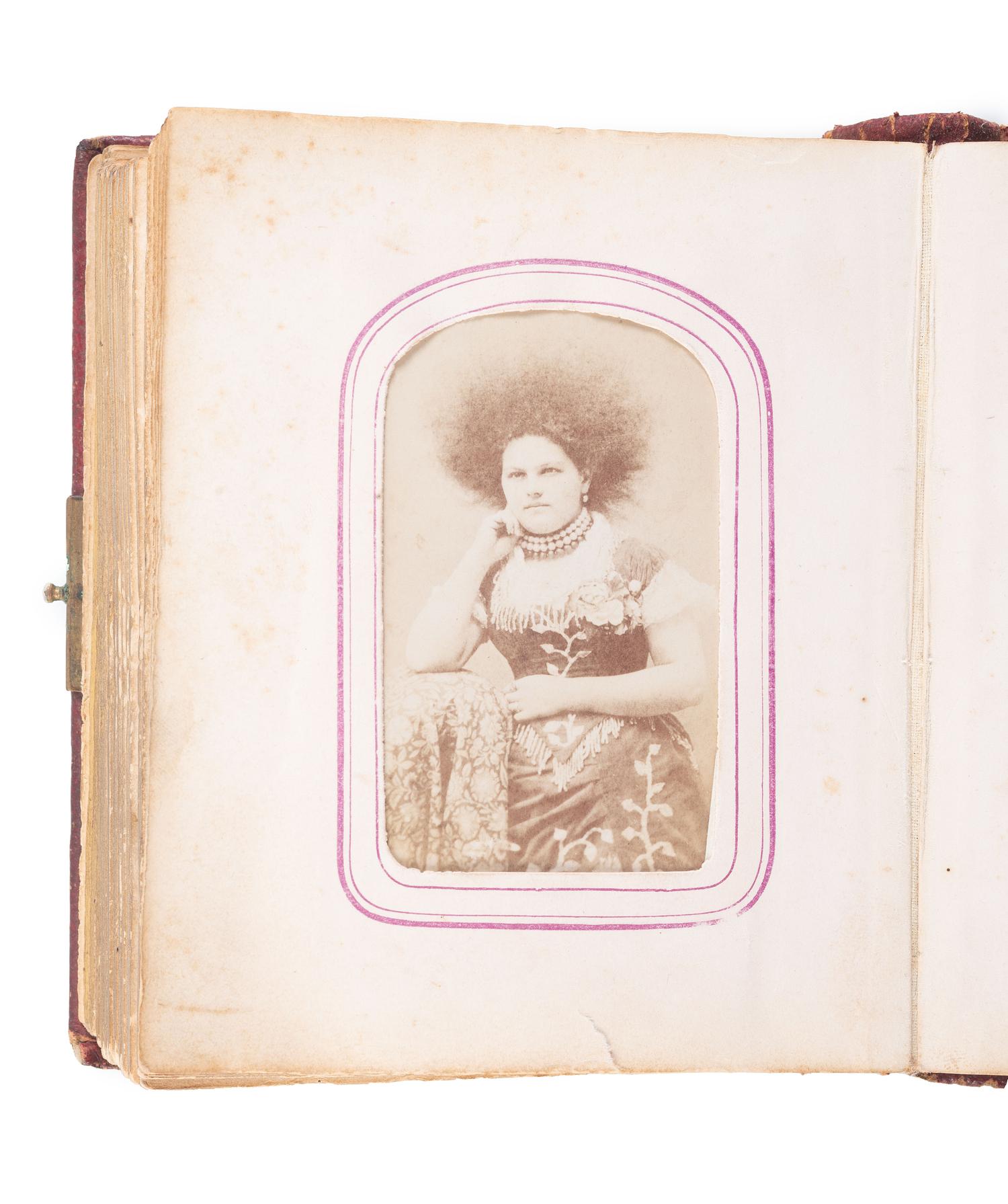 [EARLY PHOTOGRAPHY]. CDV album containing CDV of African American man and Caucasian woman.