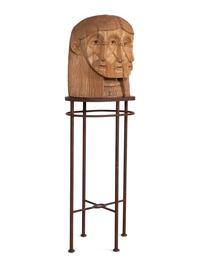 A Carved Wood Sculpture of a Three-Faced Man