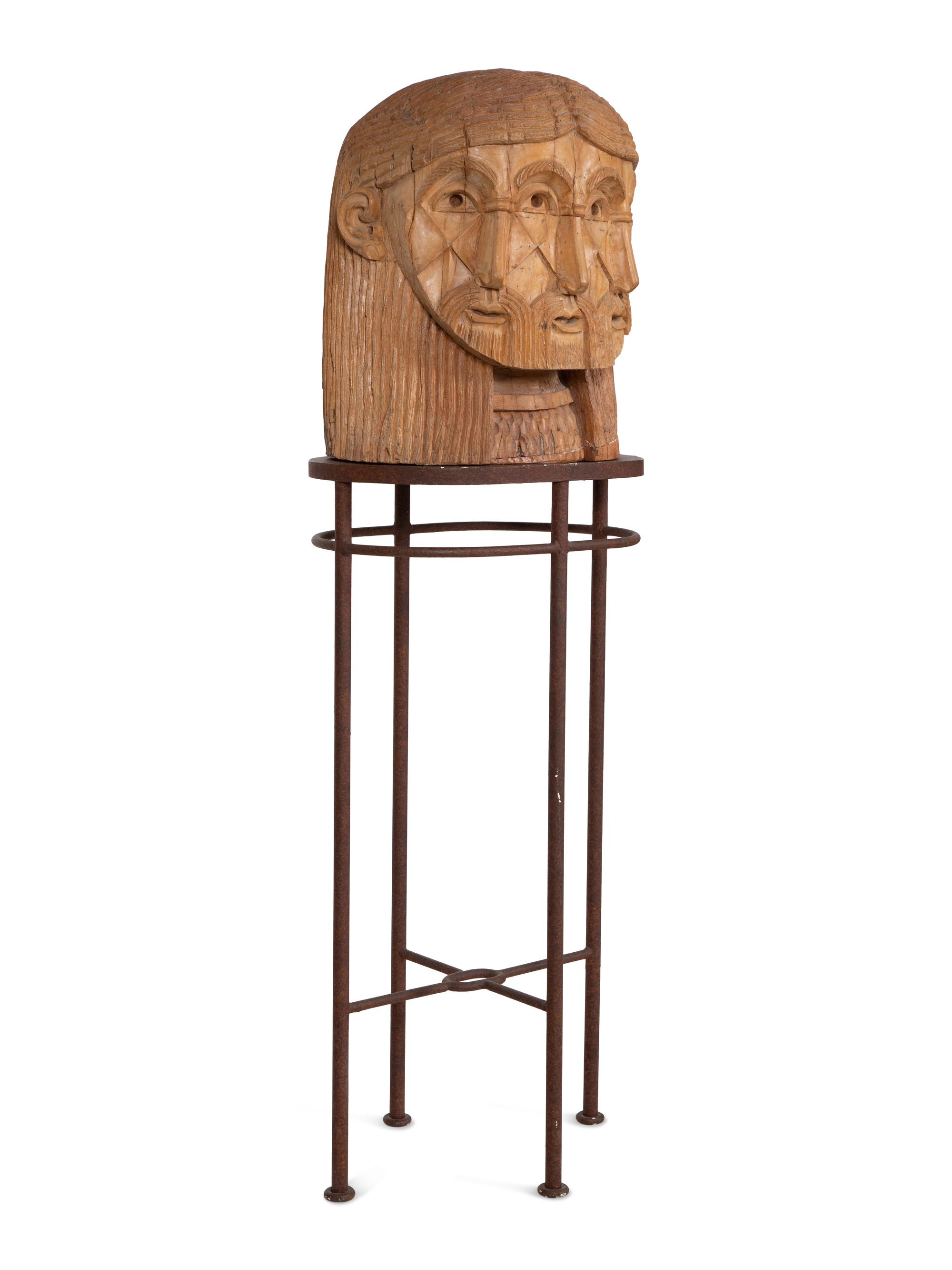 A Carved Wood Sculpture of a Three-Faced Man