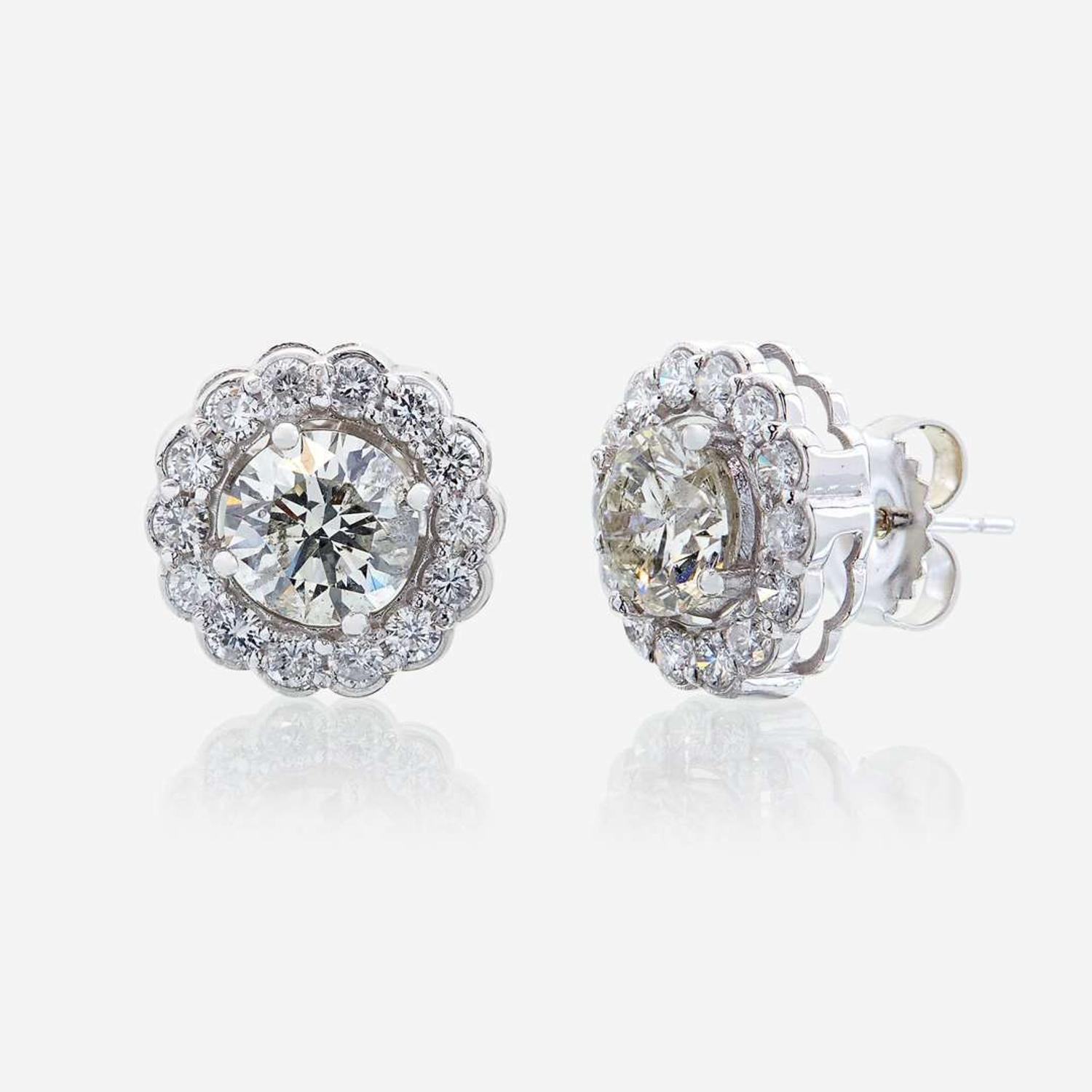 A pair of diamond and eighteen karat white gold earrings