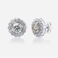 A pair of diamond and eighteen karat white gold earrings