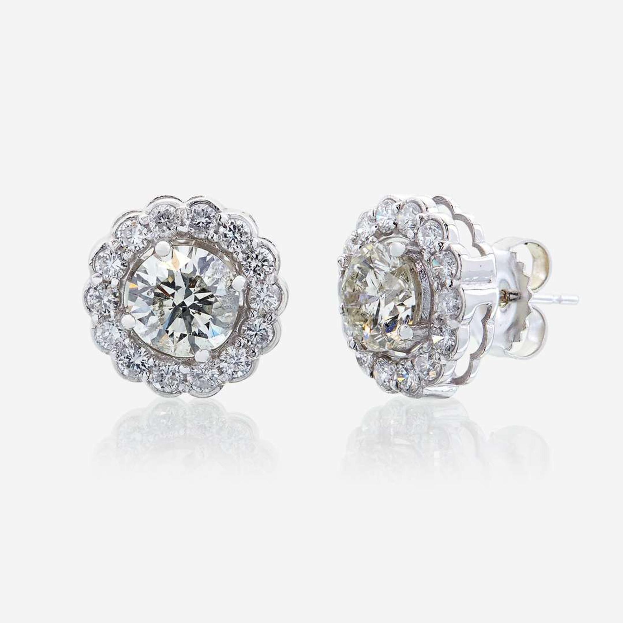 A pair of diamond and eighteen karat white gold earrings