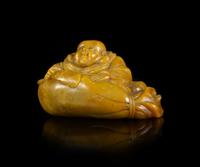 A Carved Soapstone Figure of a Laughing Buddha