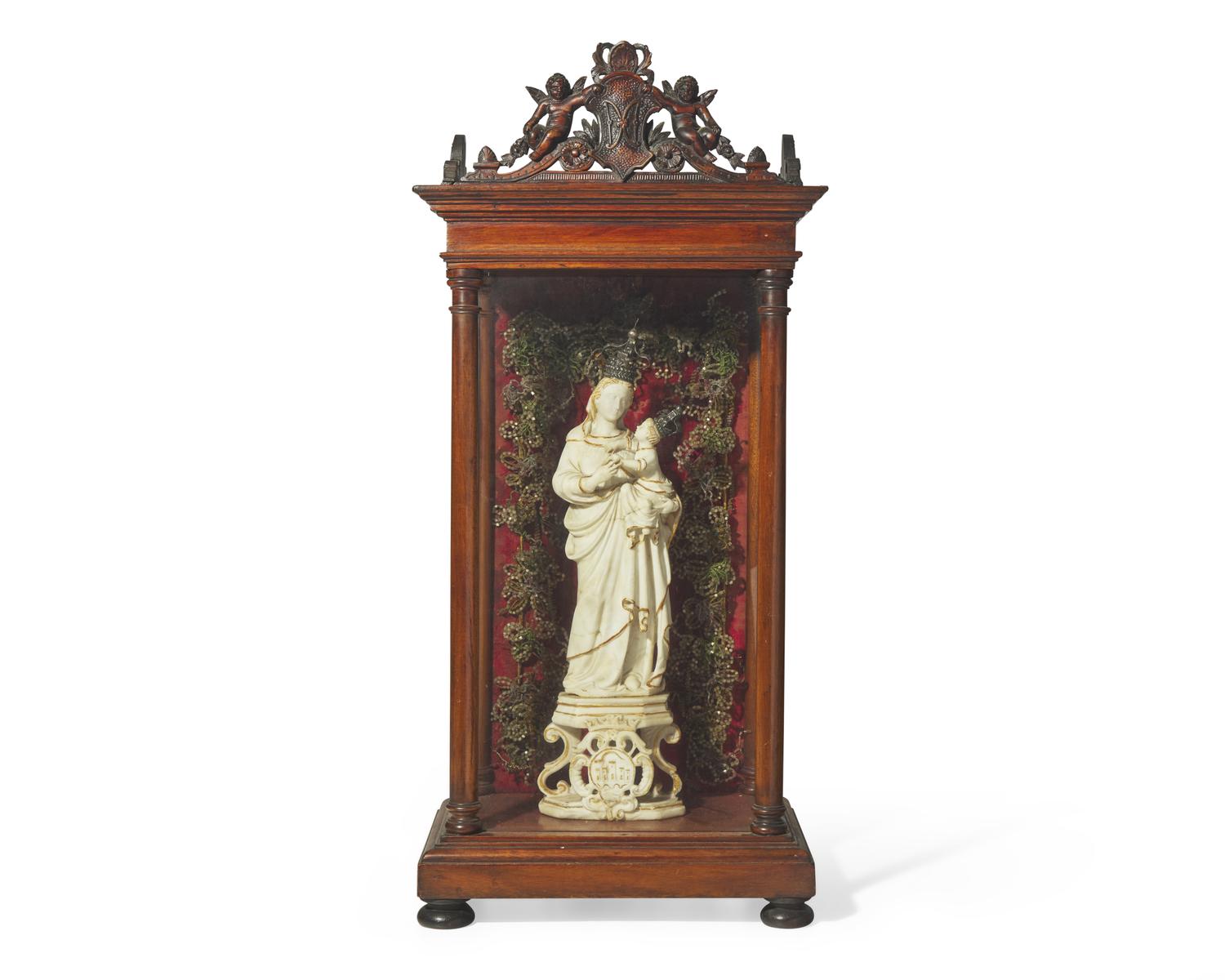 An Italian carved and parcel-gilt alabaster figure of the Madonna of Trapani, Sicily, 18th century, displayed in carved walnut and glass reliquary box, likely 19th century