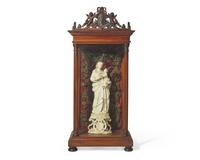 An Italian carved and parcel-gilt alabaster figure of the Madonna of Trapani, Sicily, 18th century, displayed in carved walnut and glass reliquary box, likely 19th century