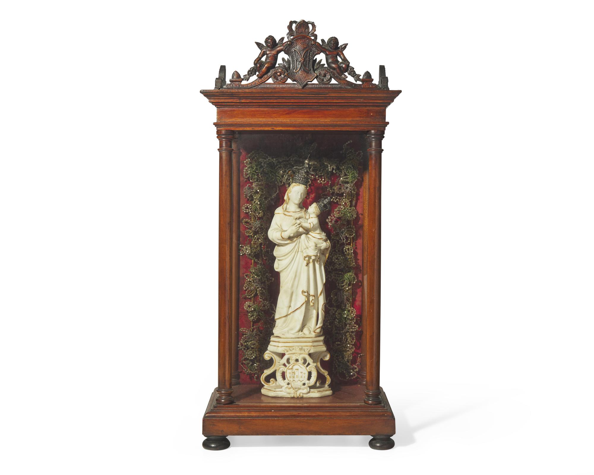 An Italian carved and parcel-gilt alabaster figure of the Madonna of Trapani, Sicily, 18th century, displayed in carved walnut and glass reliquary box, likely 19th century
