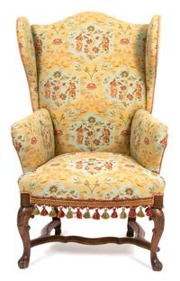 A Spanish Baroque Style Upholstered Wing Chair Height 47 x width 26 1/2 x depth 23 inches. — 19TH CENTURY