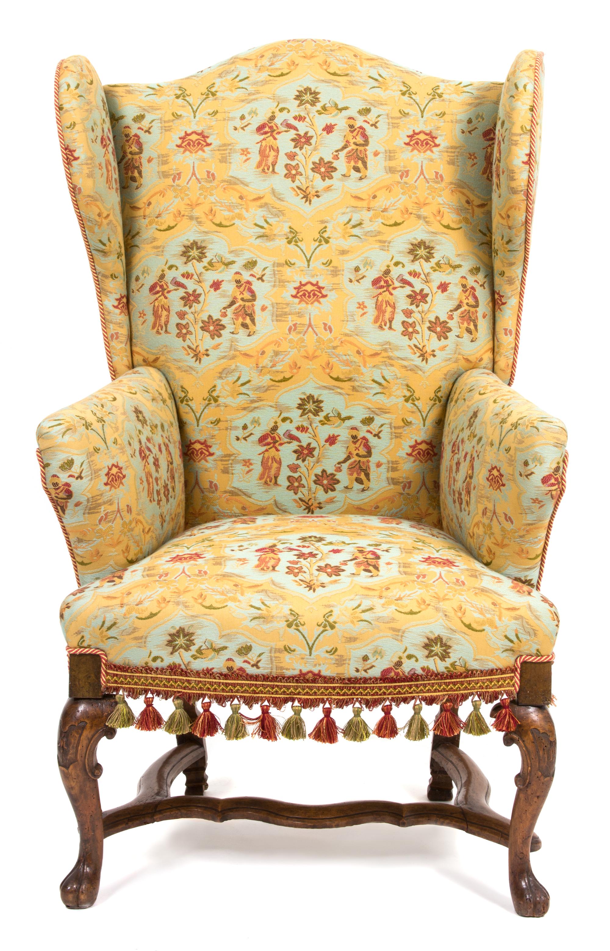 A Spanish Baroque Style Upholstered Wing Chair Height 47 x width 26 1/2 x depth 23 inches. — 19TH CENTURY